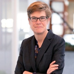 Posed Photo of Daralyn Durie in an office, black suit