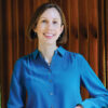Photo of Lisa Ouellette, in a blue long sleeve collared blouse.