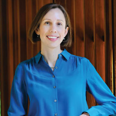 Photo of Lisa Ouellette, in a blue long sleeve collared blouse.